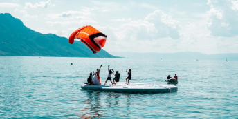 Image of a group of people launching a large kite 