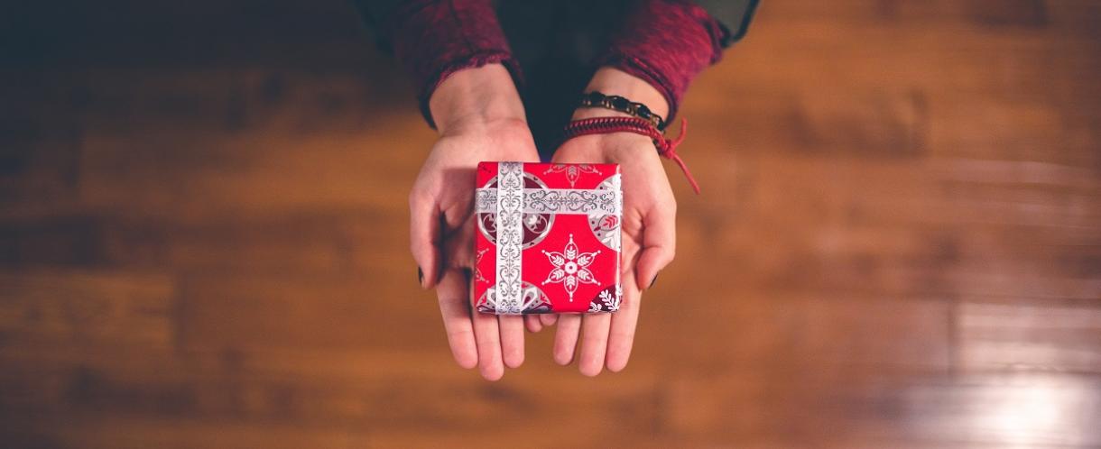 Image of hands offering a gift