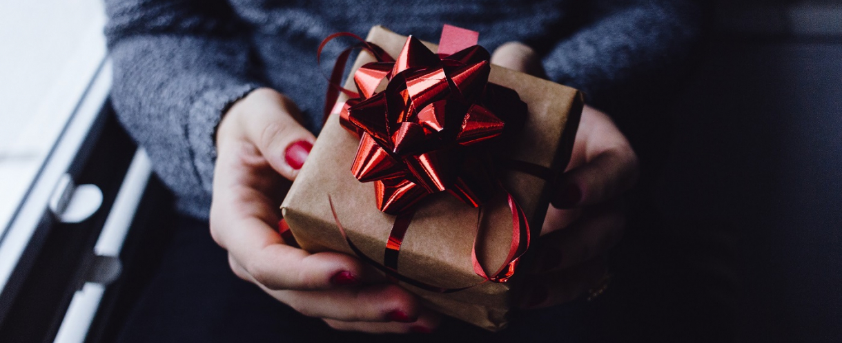 Image of someone holding a gift