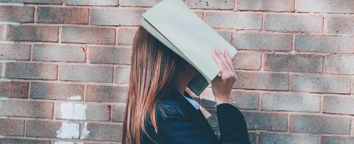 Image of woman with face in book